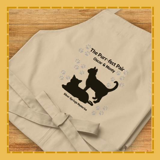 Beige towel with black cat design and text on a wooden surface