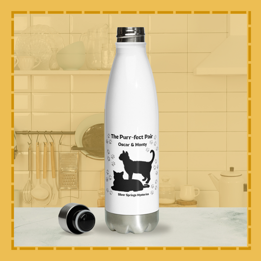 White water bottle with black cat illustrations and text on a kitchen counter.