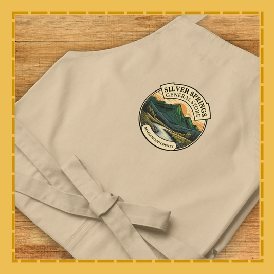 Beige apron with a logo on a wooden surface