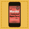Phone displaying the book cover of 'Murder at Goldenleaf Apple Farm' on a yellow background