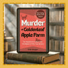 E-reader displaying 'Murder at Goldenleaf Apple Farm' on top of books with a blurred bookshelf background