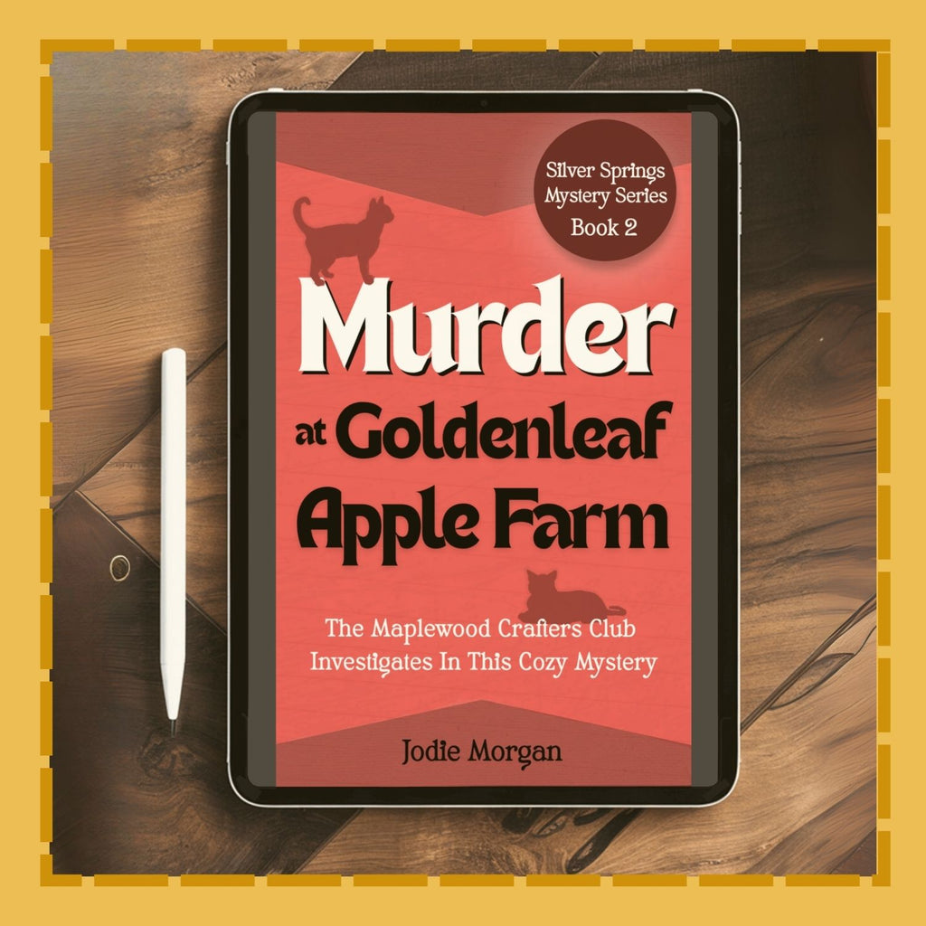 Ebook cover of 'Murder at Goldenleaf Apple Farm' on a tablet with a pen on a wooden surface.