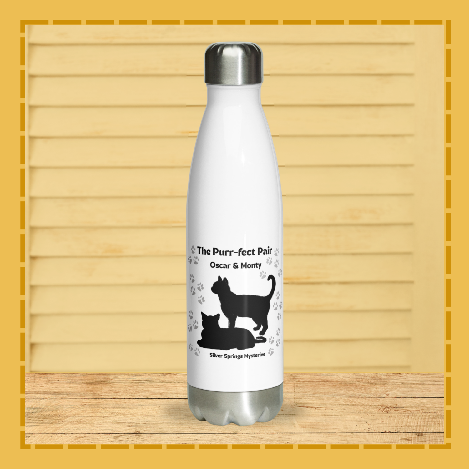 White water bottle with black cat illustrations and text on a wooden surface