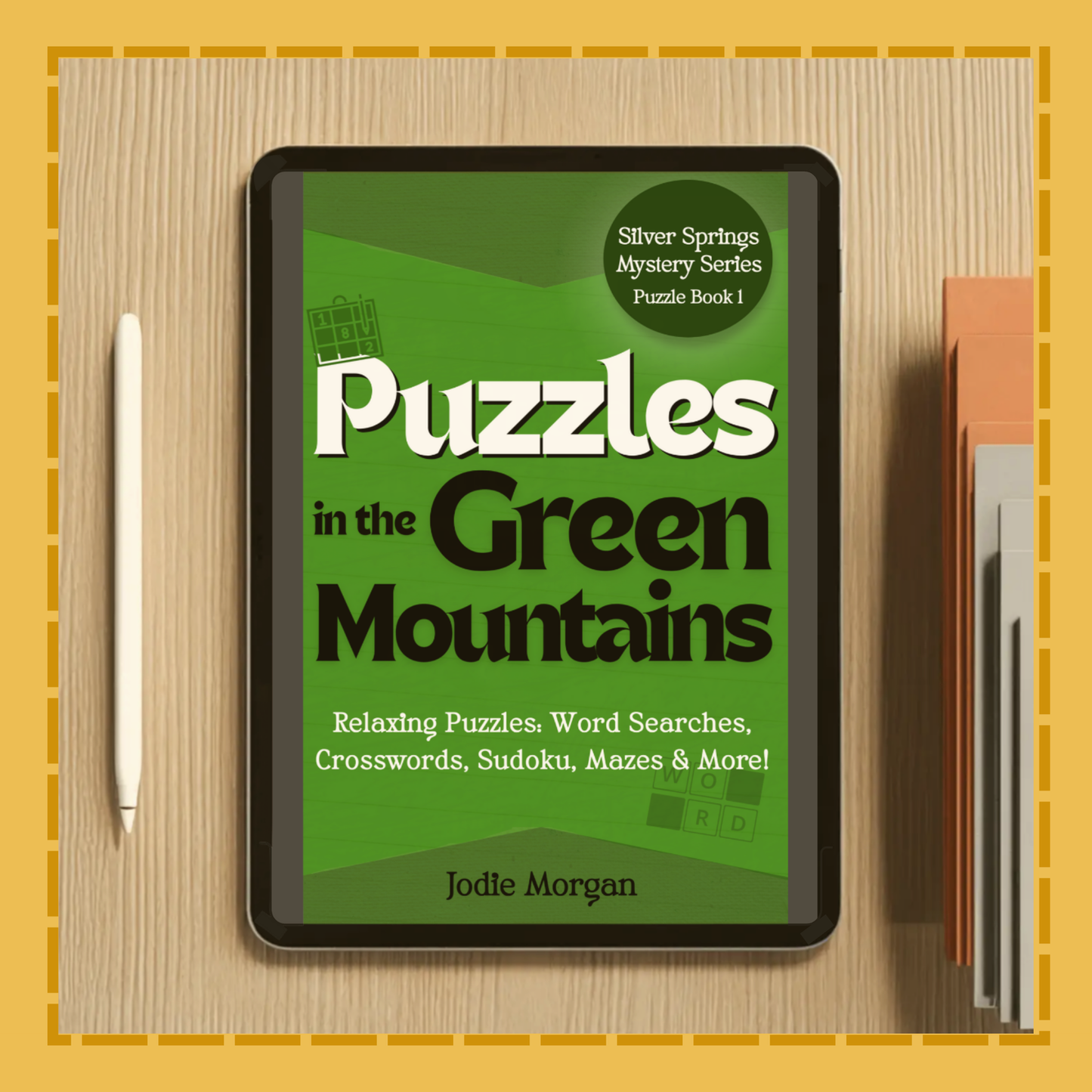Digital book cover of 'Puzzles in the Green Mountains' on a tablet with a pen and notebook on a wooden surface.