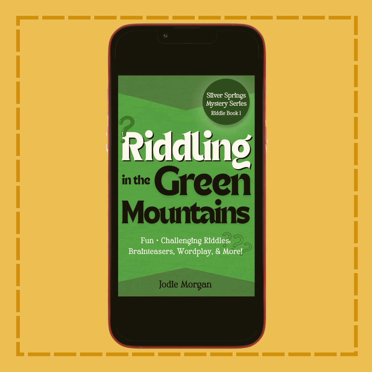 Phone displaying the book cover of 'Riddling in the Green Mountains' on a yellow background