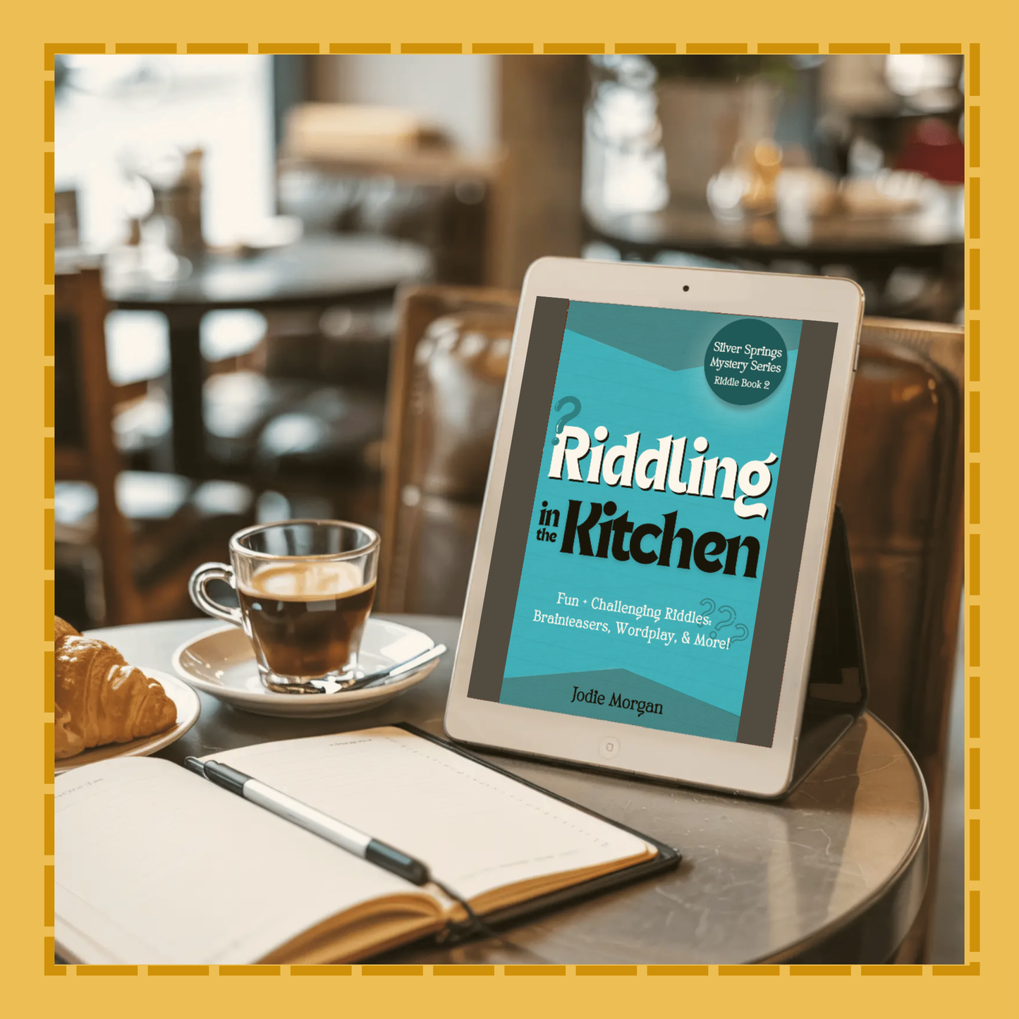 Tablet displaying 'Riddling in the Kitchen' on a table with a cup of coffee and notebook.