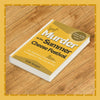 Book titled 'Murder at the Summer Cheese Festival' by Jodie Morgan on a wooden surface
