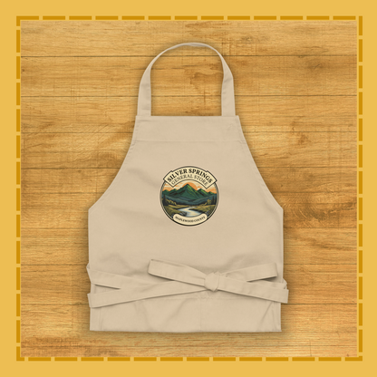 Beige apron with a logo on a wooden surface
