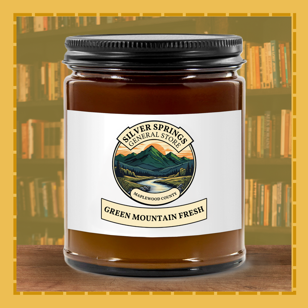 Jar of 'Green Mountain Fresh' candle with a scenic label on a bookshelf background