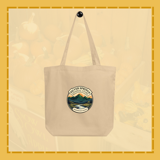 Beige tote bag with a nature-themed logo on a beige background
