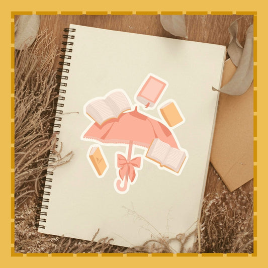 Notebook with pink umbrella sticker on a wooden surface